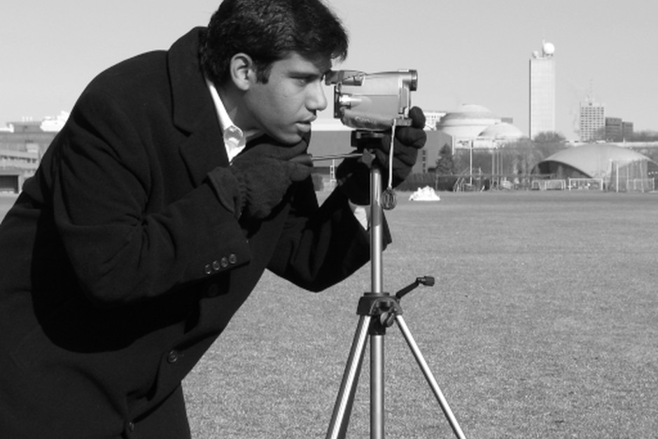 Photographer using a camera on a tripod
